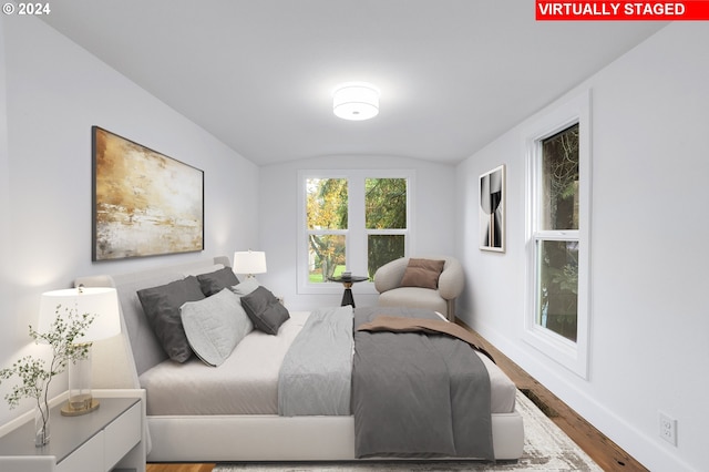 bedroom featuring lofted ceiling and wood-type flooring