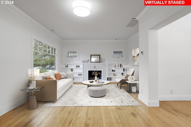 living room with hardwood / wood-style floors and ornamental molding