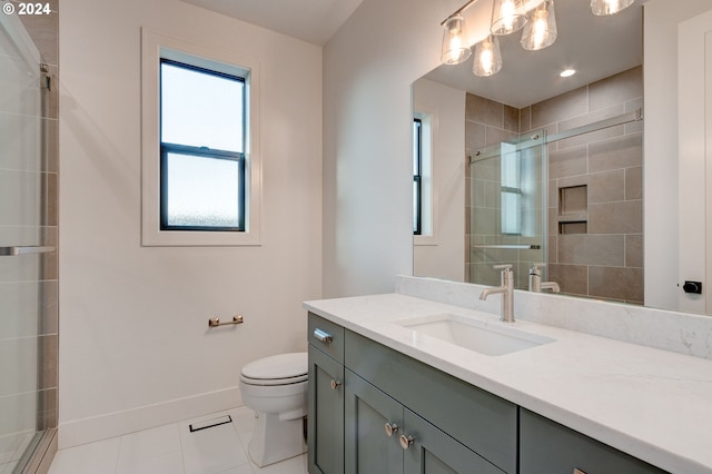 full bath with tile patterned flooring, a stall shower, vanity, baseboards, and toilet