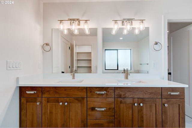 bathroom featuring a sink and double vanity