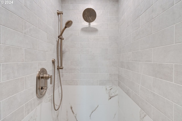 full bathroom with a tile shower