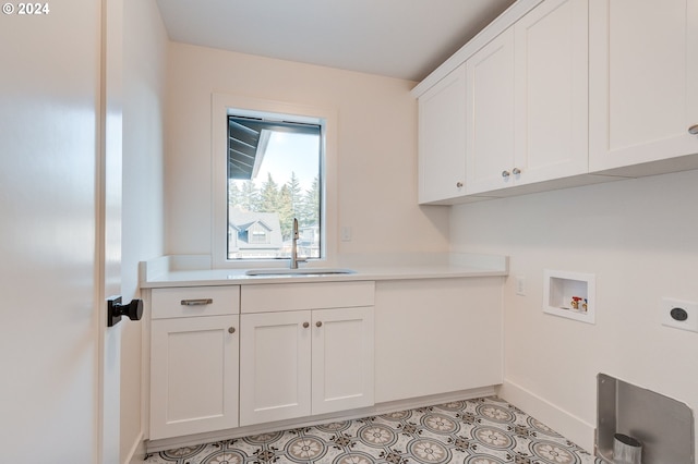 laundry area with baseboards, hookup for an electric dryer, a sink, cabinet space, and washer hookup