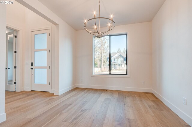 unfurnished living room with light wood-type flooring, ceiling fan, a tile fireplace, and plenty of natural light