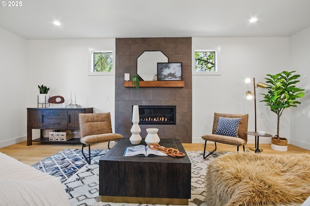 living room with plenty of natural light, recessed lighting, wood finished floors, and a fireplace