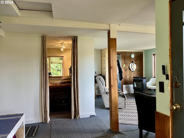 hallway with wooden walls and carpet floors