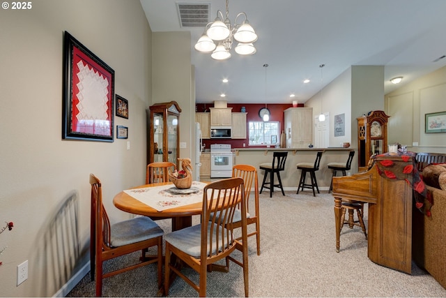 dining room featuring light carpet and a notable chandelier