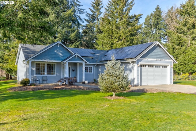 view of front facade featuring a garage, a front yard, and solar panels