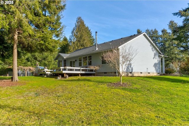 back of house with a deck and a yard