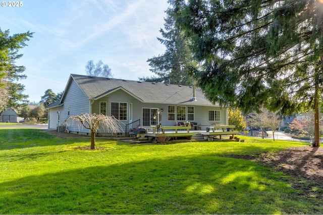 rear view of property featuring a wooden deck and a yard