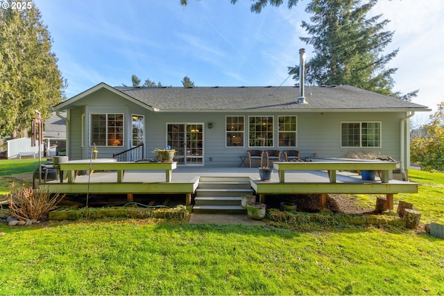 rear view of property featuring a wooden deck and a yard