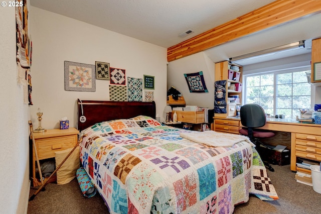 bedroom featuring carpet, a textured ceiling, and beamed ceiling