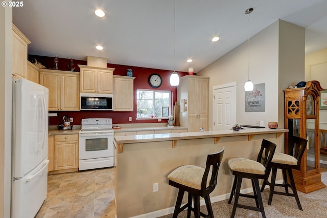 kitchen featuring light brown cabinets, white appliances, pendant lighting, and a breakfast bar