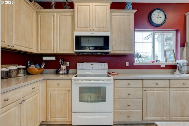 kitchen featuring white electric stove and light brown cabinets