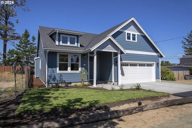 view of front of home featuring a garage and a front lawn