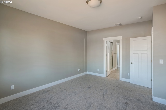 unfurnished bedroom with light colored carpet