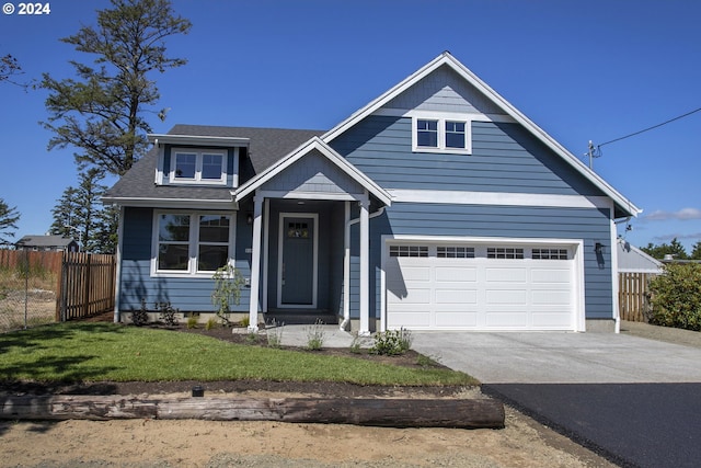 view of front facade featuring a garage and a front lawn