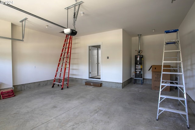 garage featuring a garage door opener and secured water heater