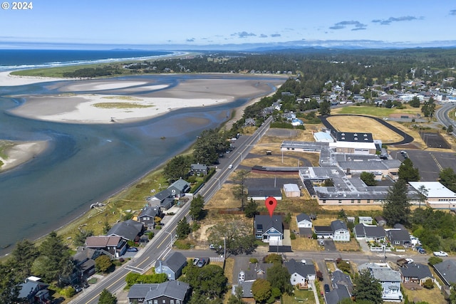 birds eye view of property featuring a view of the beach and a water view