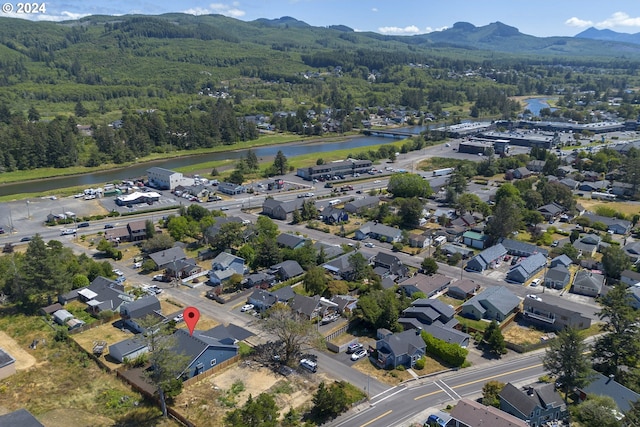 drone / aerial view featuring a water and mountain view