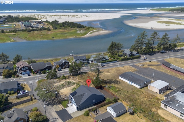 aerial view with a water view and a beach view