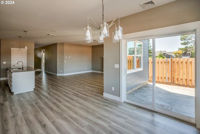 unfurnished dining area with light hardwood / wood-style floors and sink