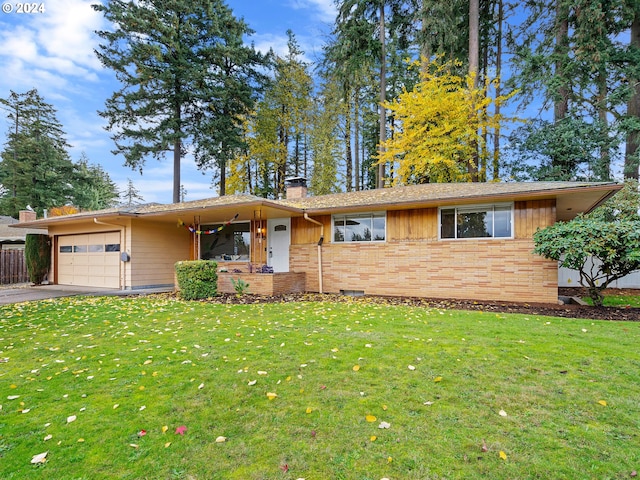 view of front of house featuring a garage and a front lawn