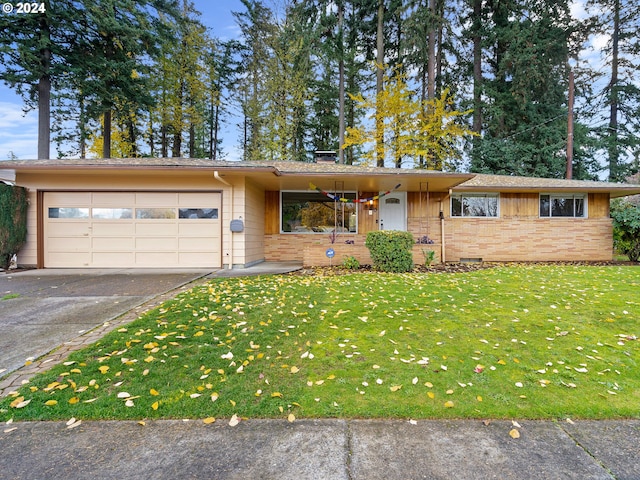 ranch-style home featuring a garage and a front lawn