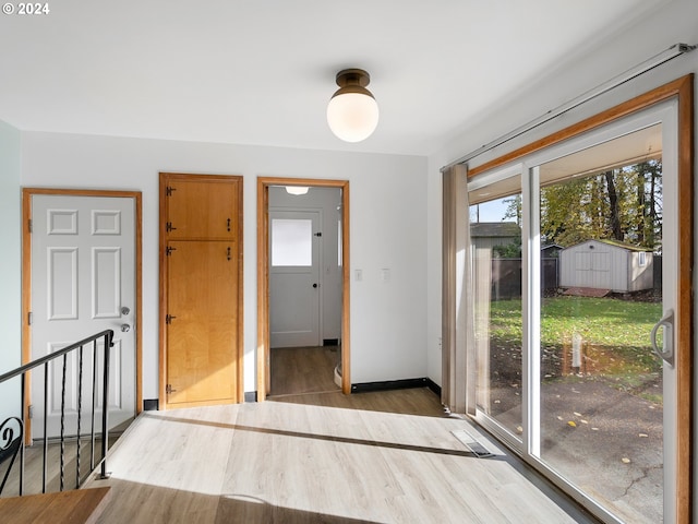 interior space featuring light wood finished floors and baseboards