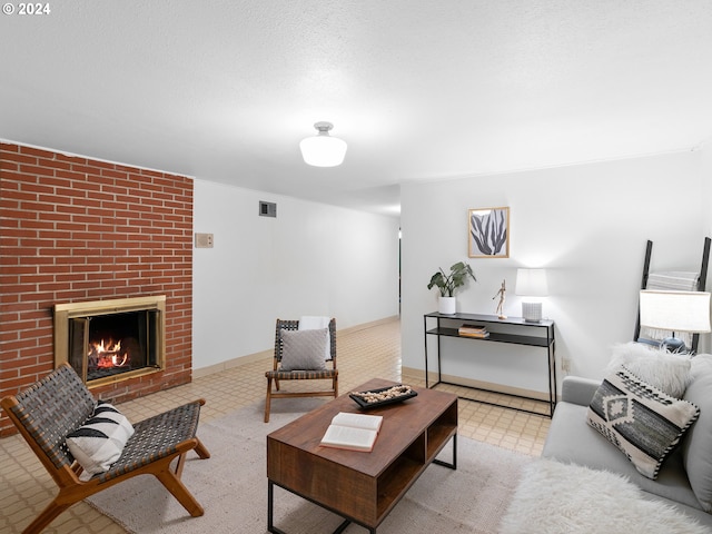 living room featuring a textured ceiling and a brick fireplace