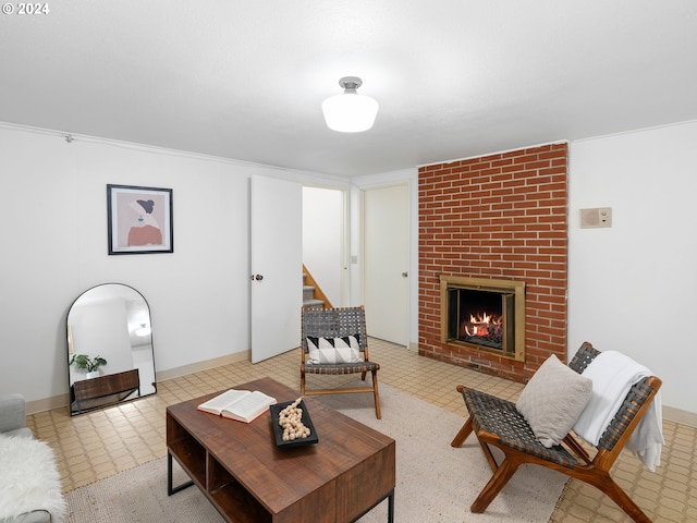 living area featuring a brick fireplace, stairway, and baseboards