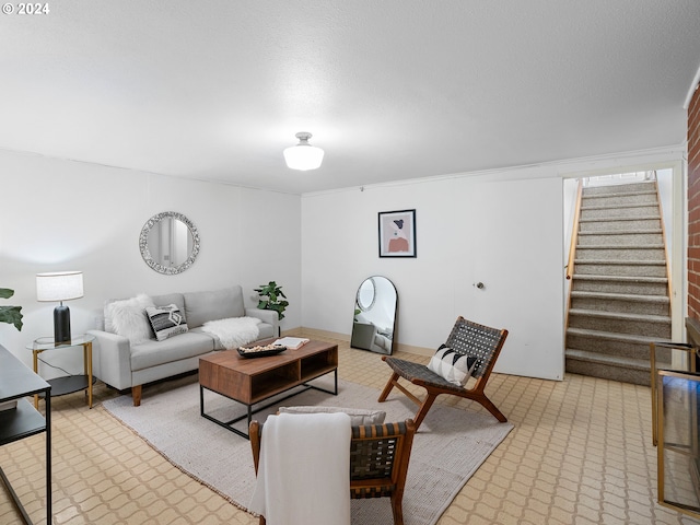 living room featuring stairs and a textured ceiling