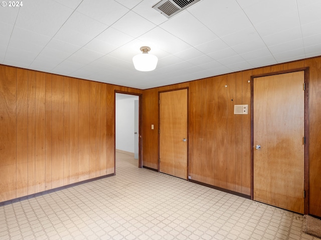 empty room featuring wood walls