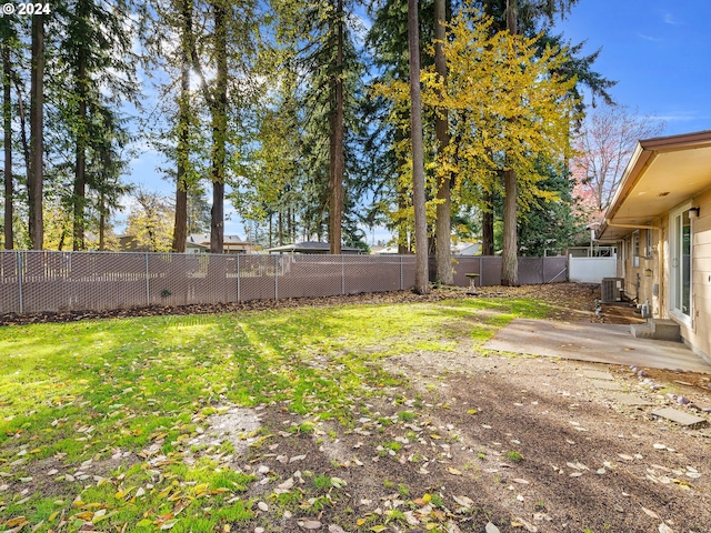 view of yard featuring central AC, a patio, and a fenced backyard