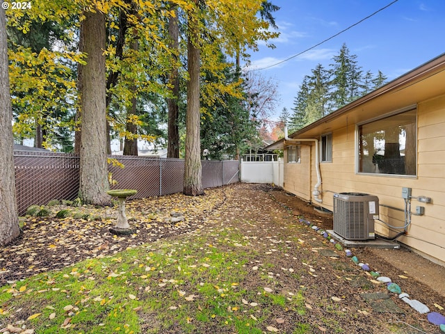 view of yard with a fenced backyard and cooling unit