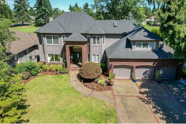 view of front of house with a front yard and a garage