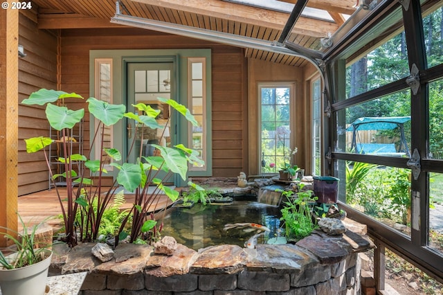 exterior space featuring wooden ceiling and vaulted ceiling