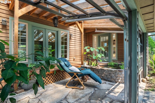 unfurnished sunroom featuring french doors and lofted ceiling