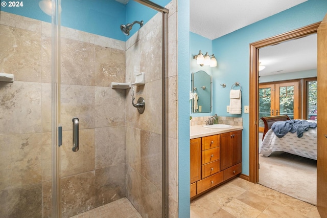 bathroom with a shower with shower door, vanity, tile patterned floors, and french doors