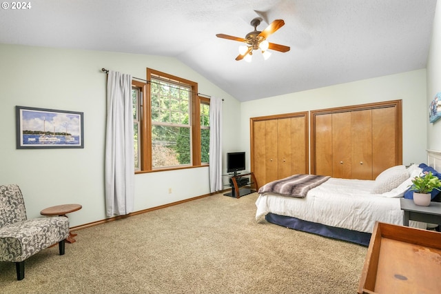 bedroom featuring ceiling fan, vaulted ceiling, and carpet floors