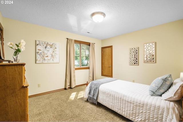 bedroom featuring a textured ceiling and carpet