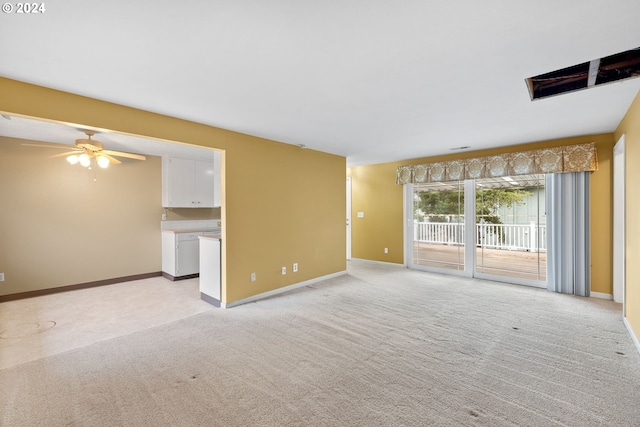 interior space featuring ceiling fan and light colored carpet