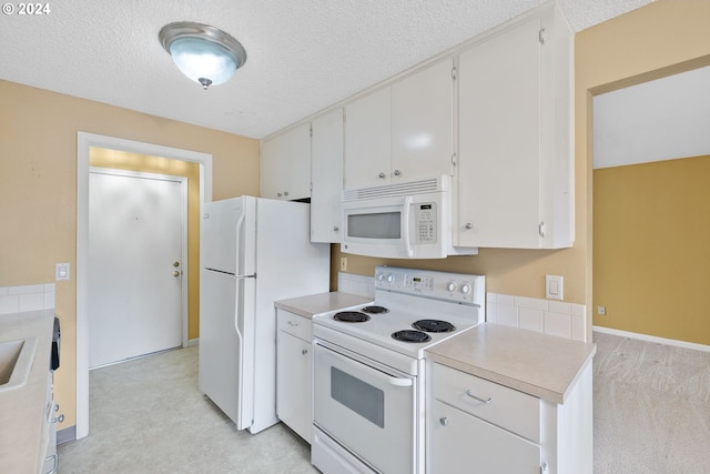 kitchen featuring white cabinetry, white appliances, light colored carpet, and a textured ceiling