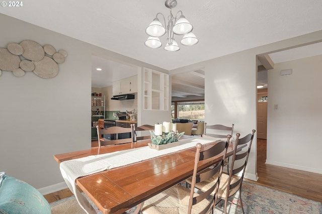 dining area with a chandelier and light hardwood / wood-style floors