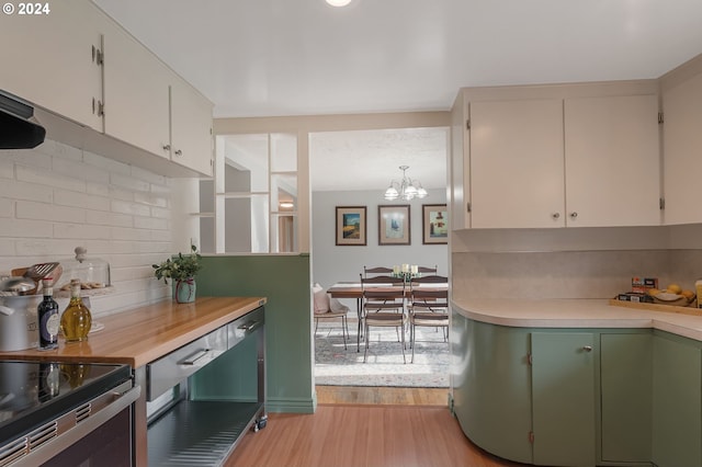 kitchen featuring decorative backsplash, light hardwood / wood-style flooring, green cabinetry, a notable chandelier, and white cabinets