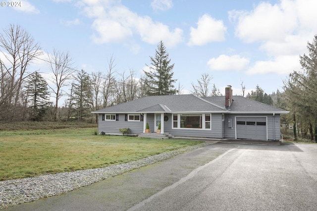 ranch-style house featuring a front yard and a garage