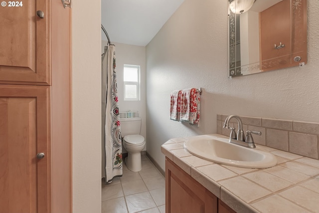 bathroom featuring tile patterned floors, vanity, and toilet