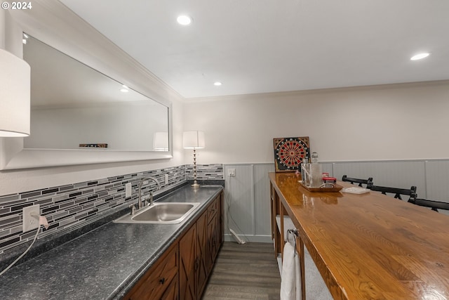 kitchen featuring wood counters, dark hardwood / wood-style floors, crown molding, and sink