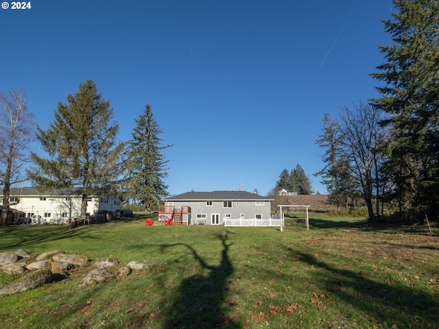 back of property featuring a yard