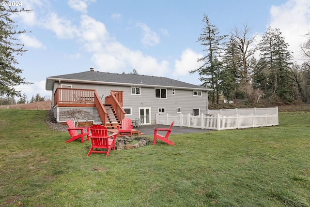 rear view of house with a patio, a yard, a deck, and an outdoor fire pit