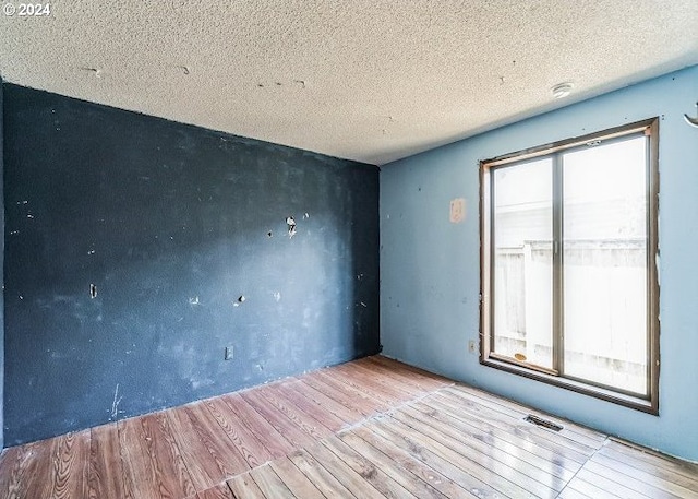 1730 SW 203rd Ave, Beaverton, OR 97003 - spare room with wood finished floors and a textured ceiling